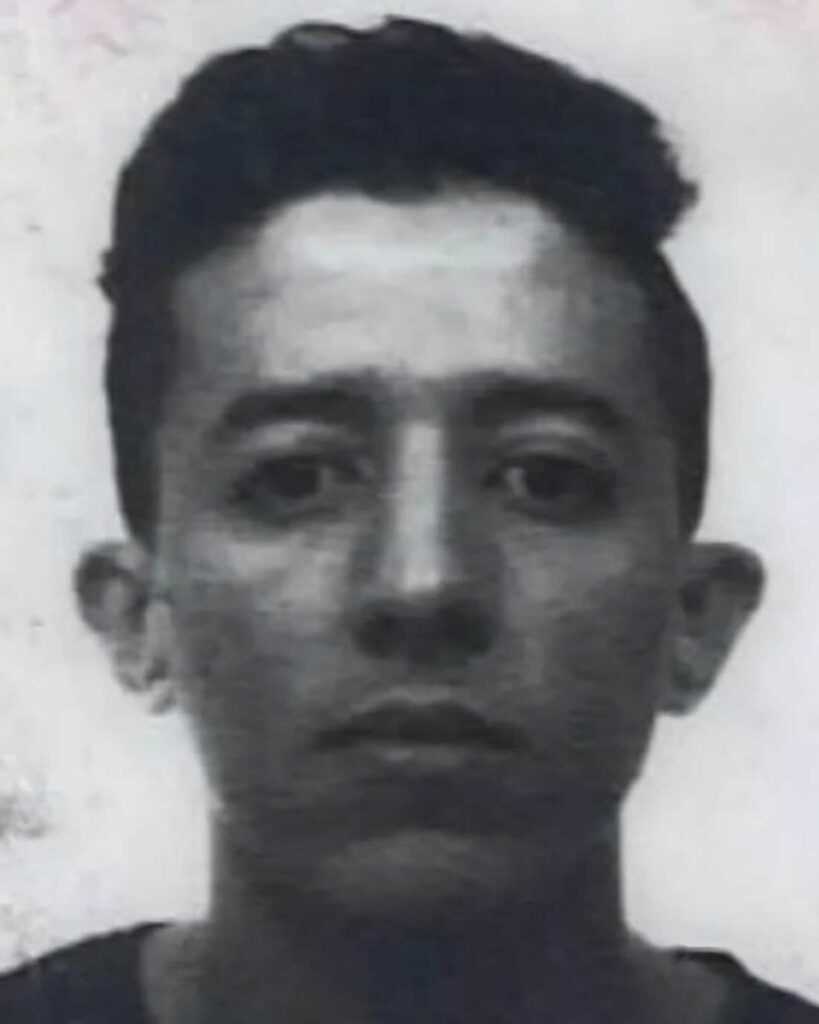 grayscale portrait of a man facing the camera with a neutral expression